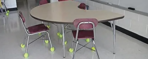 Classroom table and chairs with tennis balls installed on chair legs